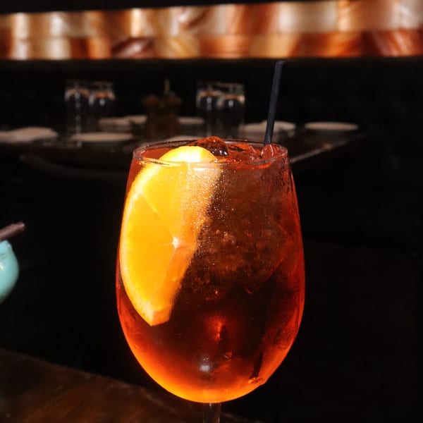 A refreshing orange cocktail with ice and an orange slice, served at Jack's Bar And Steakhouse.